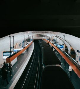 paris metro station with passengers and train