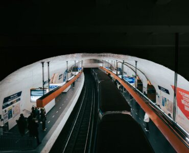 paris metro station with passengers and train