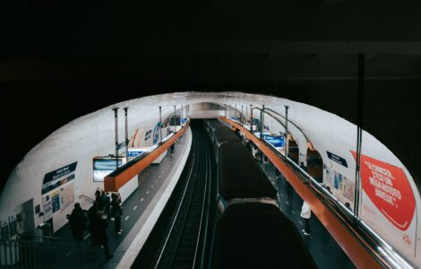paris metro station with passengers and train