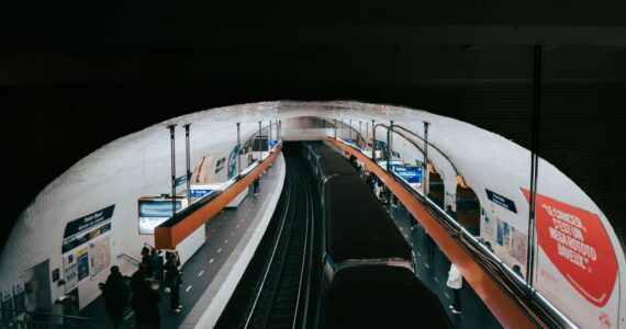 paris metro station with passengers and train