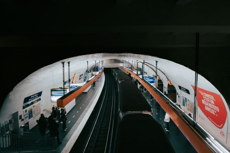 paris metro station with passengers and train