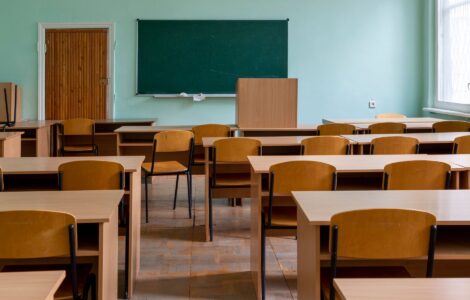 Salle de classe vide avec bureaux et tableau